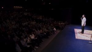 Clean stand-up comedian Shaun Eli in front of an applauding audience