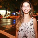 Comedian Liz Miele standing on a dark NYC street