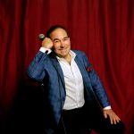 Shaun Eli seated at Broadway Comedy Club